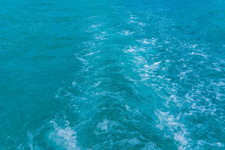 Trail on sea water surface behind boat